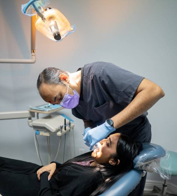 Dentist Performing Tooth Extraction Procedure – Elite Dental Inverness FL